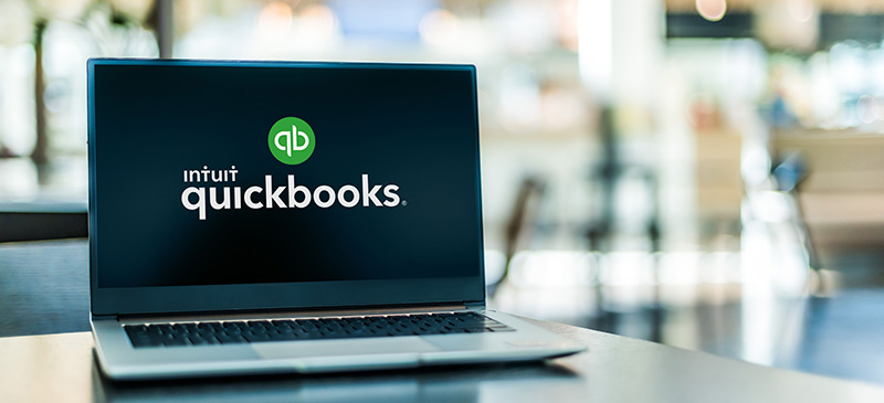 a computer with quickbooks branding on the screen.